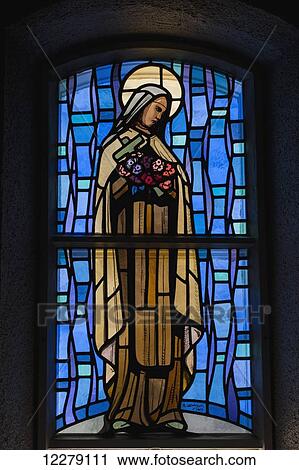 Stock Image - Detail of saint in stained glass windows of Saint-Michel Basilica-Cathedral; Sherbrooke, Quebec, Canada. Fotosearch