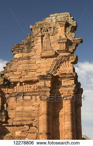 Stock Photograph - Details of the artwork in the stone entrance of the ruins of a Jesuit mission temple; Missiones, Argentina. Fotosearch