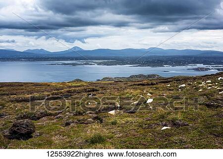 Stock Photograph - Distant mountain range viewed from the Atlantic coastline; Ireland. Fotosearch