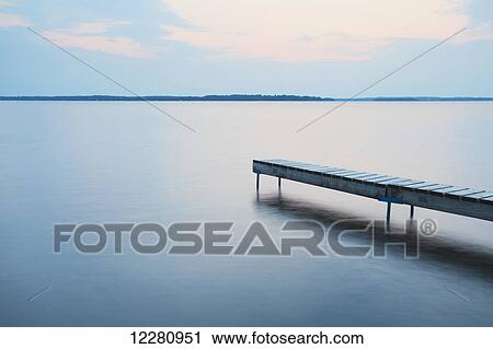 Stock Image - Dock at sunrise on Balsam Lake; Ontario, Canada. Fotosearch