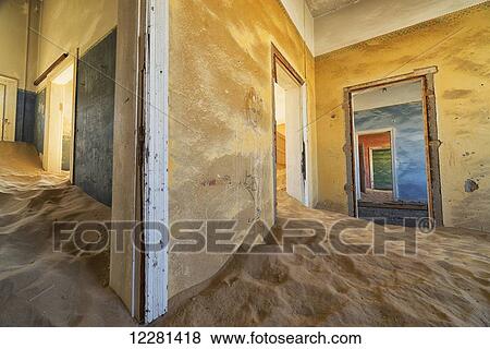 Drifting sand fills the rooms of a colourful abandoned house; Kolmanskop, Namibia View Large Photo Image Stock Photo - Drifting sand fills the rooms of a colourful abandoned house; Kolmanskop, Namibia. Fotosearch