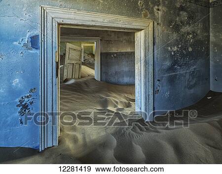 Drifting sand fills the rooms of a colourful abandoned house; Kolmanskop, Namibia View Large Photo Image Stock Photo - Drifting sand fills the rooms of a colourful abandoned house; Kolmanskop, Namibia. Fotosearch