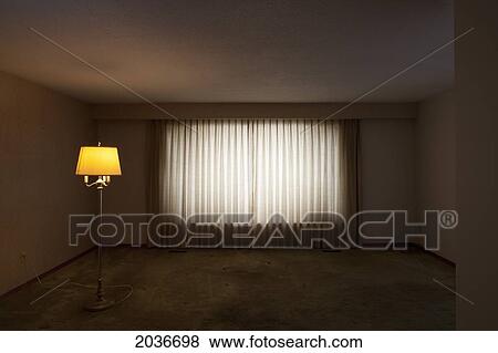 Stock Photo - Empty Living Room With An Illuminated Floor Lamp. Fotosearch