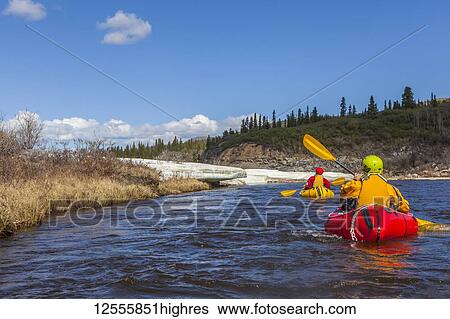 Female packrafters negotiating a tributary of the Charley River with aufeis in summer; Alaska, United States of America View Large Photo Image Stock Photograph - Female packrafters negotiating a tributary of the Charley River with aufeis in summer; Alaska, United States of America. Fotosearch