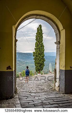 Female tourist looking out from the hilltop medieval town of Motovun; Motovun, Istria, Croatia View Large Photo Image Stock Photograph - Female tourist looking out from the hilltop medieval town of Motovun; Motovun, Istria, Croatia. Fotosearch