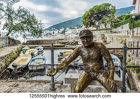 Stock Photograph - Fisherman sculpture with coins in it's hand in a harbour; Opatija, Primorje-Gorski Kotar County, Croatia. Fotosearch
