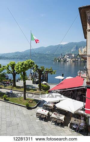 Flag of Italy flying at the waterfront beside a restaurant patio on Lake Orta; Orta, Piedmont, Italy View Large Photo Image Stock Image - Flag of Italy flying at the waterfront beside a restaurant patio on Lake Orta; Orta, Piedmont, Italy. Fotosearch