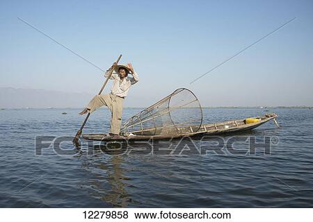 Friendly, smiling traditional leg paddling fisherman on Inle Lake; Myanmar View Large Photo Image Stock Photo - Friendly, smiling traditional leg paddling fisherman on Inle Lake; Myanmar. Fotosearch