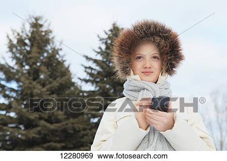 Girl texting on smart phone outdoors in winter; Toronto, Ontario, Canada View Large Photo Image Stock Photo - Girl texting on smart phone outdoors in winter; Toronto, Ontario, Canada. Fotosearch