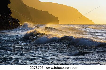 Stock Photograph - Golden surf looking down the Na Pali Coast; Wainiha, Kauai, Hawaii, United States of America. Fotosearch