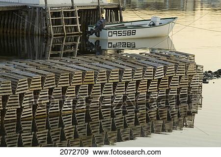 Harbour Reflections, Lobster Traps And Boat, Twillingate, Newfoundland & Labrador View Large Photo Image Stock Photo - Harbour Reflections, Lobster Traps And Boat, Twillingate, Newfoundland & Labrador. Fotosearch
