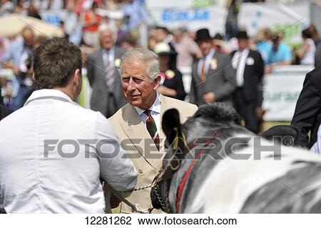 Stock Image - His Royal Highness Charles meeting farmers at the 2013 Royal Welsh Show; Wales. Fotosearch