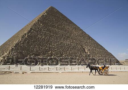Stock Photo - Horse cart for tourist, Great Pyramid of Cheops (background), the Giza Pyramids; Giza, Egypt. Fotosearch