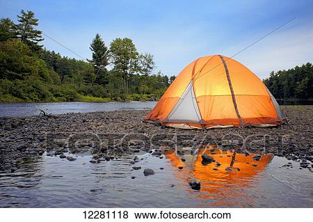 Stock Photo - Illuminated tent on the Muskoka river; Bracebridge, Ontario, Canada. Fotosearch