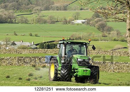 John Deere 6126r spreading fertilizer on upland pasture; Lancashire, England View Large Photo Image Stock Image - John Deere 6126r spreading fertilizer on upland pasture; Lancashire, England. Fotosearch
