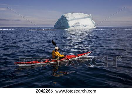 Kayaker Paddling Past An Iceberg, Quirpon Island, Newfoundland & Labrador View Large Photo Image Stock Photography - Kayaker Paddling Past An Iceberg, Quirpon Island, Newfoundland & Labrador. Fotosearch