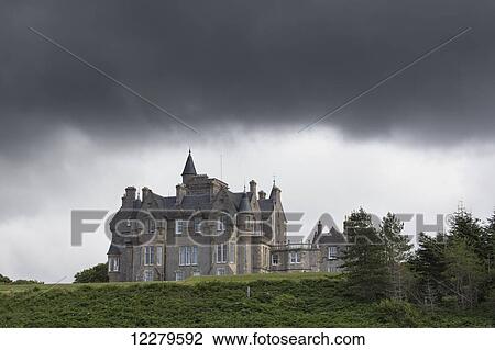 Stock Image - Large house under storm clouds; Isle of Mull, Argyll and Bute, Scotland. Fotosearch