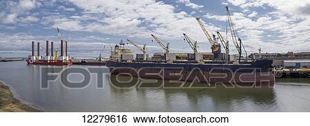 Large ship moored in a harbour with cranes on the shore; Sunderland, Tyne and Wear, England View Large Photo Image Stock Photograph - Large ship moored in a harbour with cranes on the shore; Sunderland, Tyne and Wear, England. Fotosearch