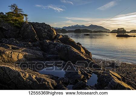 Late day winter sun on rocky beach overlooking Crescent Bay; Sitka, Alaska, United States of America View Large Photo Image Stock Photograph - Late day winter sun on rocky beach overlooking Crescent Bay; Sitka, Alaska, United States of America. Fotosearch