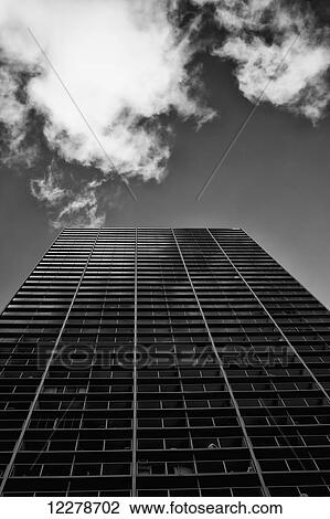 Stock Image - Looking up at a tall building in Waikiki processed in high contrast black and white; Honolulu, Oahu, Hawaii, United States of America. Fotosearch