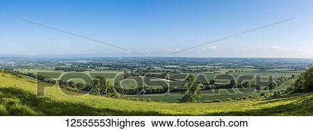 Stock Photograph - Lush green fields of farmland with blue sky and horizon in the distance; Meopham, Kent, Croatia. Fotosearch
