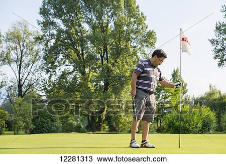 Stock Image - Male golfer on a golf course; Locarno, Ticino, Switzerland. Fotosearch