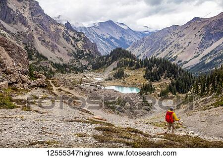 Stock Photograph - Male hiker in Royal Basin, Olympic Mountains, Olympic National Park; Washington, United States of America. Fotosearch