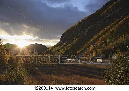 Motorhome on the Glenn Highway heading into the sunset, Talkeetna Mountains, Southcentral Alaska, Autumn View Large Photo Image Picture - Motorhome on the Glenn Highway heading into the sunset, Talkeetna Mountains, Southcentral Alaska, Autumn. Fotosearch
