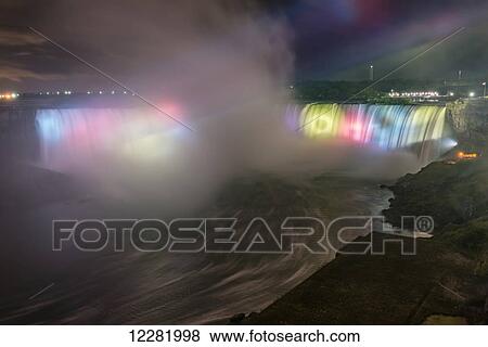 Stock Photo - Night view of illuminated and colorful Horseshoe Falls; Niagara Falls, Ontario, Canada. Fotosearch