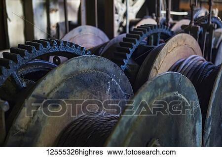 Stock Photograph - Old relics of gold mining equipment inside the Coal Creek Dredge; Coal Creek, Alaska, United States of America. Fotosearch