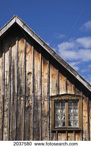 Old Wooden Siding And Pane Glass Window On The Side Of An Old