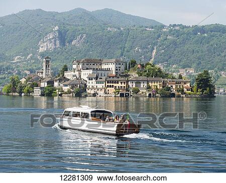 Passengers in a boat on Lake Orta; Orta, Piedmont, Italy View Large Photo Image Stock Photo - Passengers in a boat on Lake Orta; Orta, Piedmont, Italy. Fotosearch
