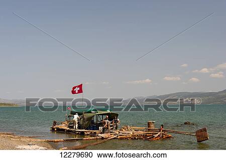 People on a handmade raft moored along the lakeshore of Lake Leberge, Yukon Territory, Canada View Large Photo Image Stock Image - People on a handmade raft moored along the lakeshore of Lake Leberge, Yukon Territory, Canada. Fotosearch