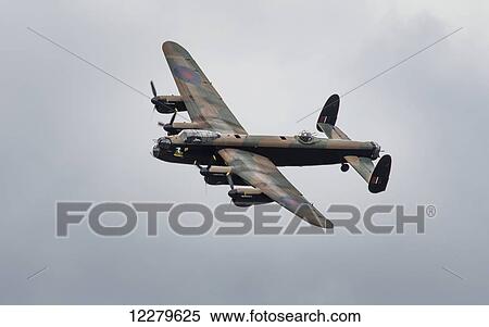 Stock Photography - Plane in a cloudy sky with camouflage pattern; Sunderland, Tyne and Wear, England. Fotosearch