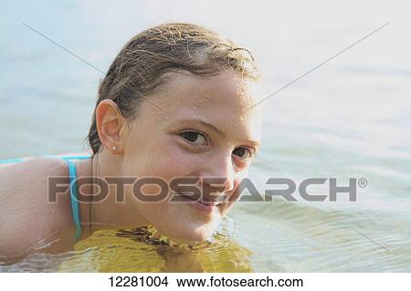 Picture - Portrait of a girl swimming in Crystal Lake; Ontario, Canada. Fotosearch