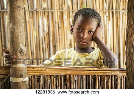 Portrait of a young boy in Sexaxa village; Maun, Botswana View Large Photo Image Stock Photography - Portrait of a young boy in Sexaxa village; Maun, Botswana. Fotosearch