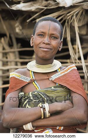 Stock Photograph - Portrait of Datoga woman wearing traditional clothing and jewelry, near Lake Eyasi; Tanzania. Fotosearch