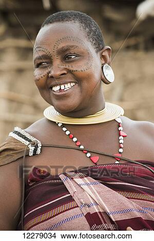 Portrait of Datoga woman with tattooed face and wearing traditional clothing and jewelry, near Lake Eyasi; Tanzania View Large Photo Image Picture - Portrait of Datoga woman with tattooed face and wearing traditional clothing and jewelry, near Lake Eyasi; Tanzania. Fotosearch