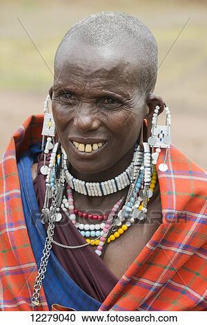 Portrait of Maasai woman wearing traditional clothing and beaded jewelry, Ngorongoro Conservation Area; Tanzania View Large Photo Image Stock Image - Portrait of Maasai woman wearing traditional clothing and beaded jewelry, Ngorongoro Conservation Area; Tanzania. Fotosearch