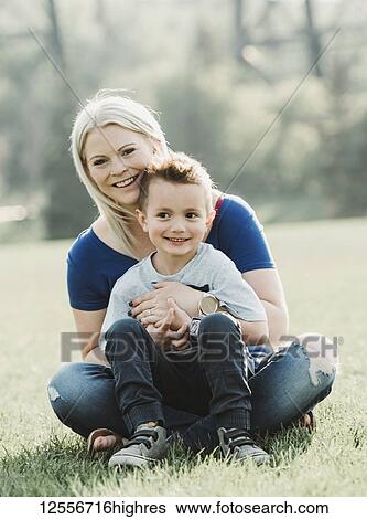 Portrait of mother with young son sitting on the grass in a park; Edmonton, Alberta, Canada View Large Photo Image Stock Photograph - Portrait of mother with young son sitting on the grass in a park; Edmonton, Alberta, Canada. Fotosearch