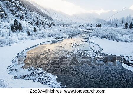 River flowing through a snowy, mountainous landscape at sunrise; Alaska, United States of America View Large Photo Image Stock Photograph - River flowing through a snowy, mountainous landscape at sunrise; Alaska, United States of America. Fotosearch