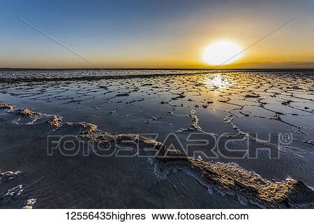 Stock Photograph - Salt flats of Lake Karum (Lake Assale) at sunset, Danakil Depression; Afar Region, Ethiopia. Fotosearch