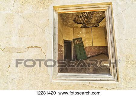 Stock Image - Sand in the rooms of a colourful and abandoned house; Kolmanskop, Namibia. Fotosearch
