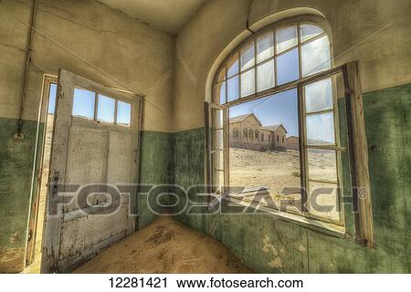Stock Image - Sand in the rooms of a colourful and abandoned house; Kolmanskop, Namibia. Fotosearch