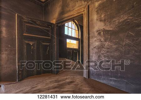 Stock Image - Sand in the rooms of a colourful and abandoned house; Kolmanskop, Namibia. Fotosearch