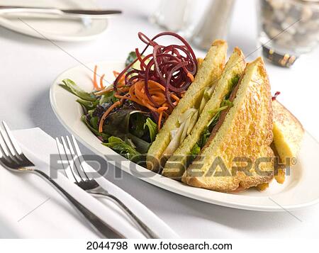 Stock Photo - Sandwich And Salad With Place Setting On White Table Top. Fotosearch