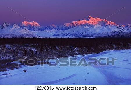 Stock Photography - Scenic winter view of Mt. McKinley and the Alaska range at sunrise with the frozen Chulitna River in the foreground, Southcentral Alaska. Fotosearch