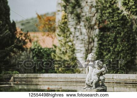 Sculpture in a pool in the garden of Duino Castle; Italy View Large Photo Image Stock Photograph - Sculpture in a pool in the garden of Duino Castle; Italy. Fotosearch