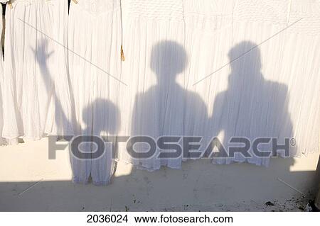 Picture - Shadows Of Family On Wall, Santorini, Greece. Fotosearch