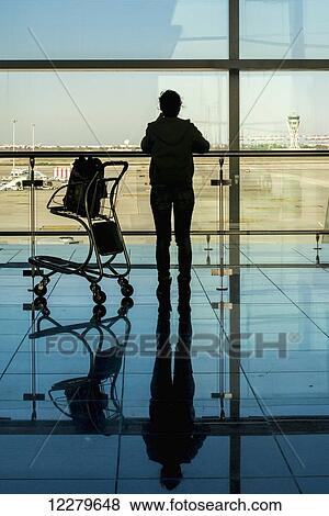 Stock Photo - Silhouette of traveller at Barcelona Airport; Barcelona, Spain. Fotosearch